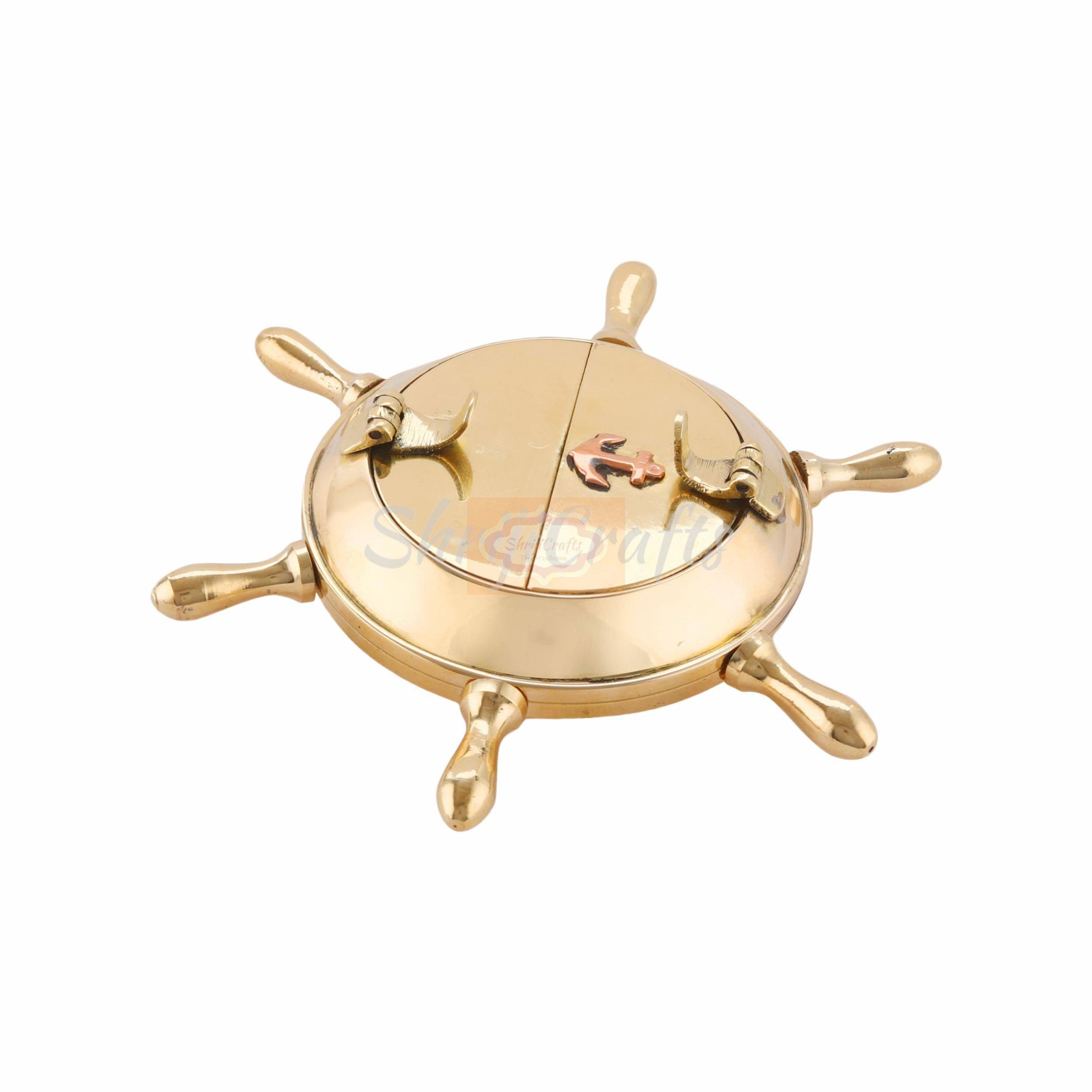 Handcrafted brass ashtray featuring a classic nautical ship wheel design with a polished finish - View 3