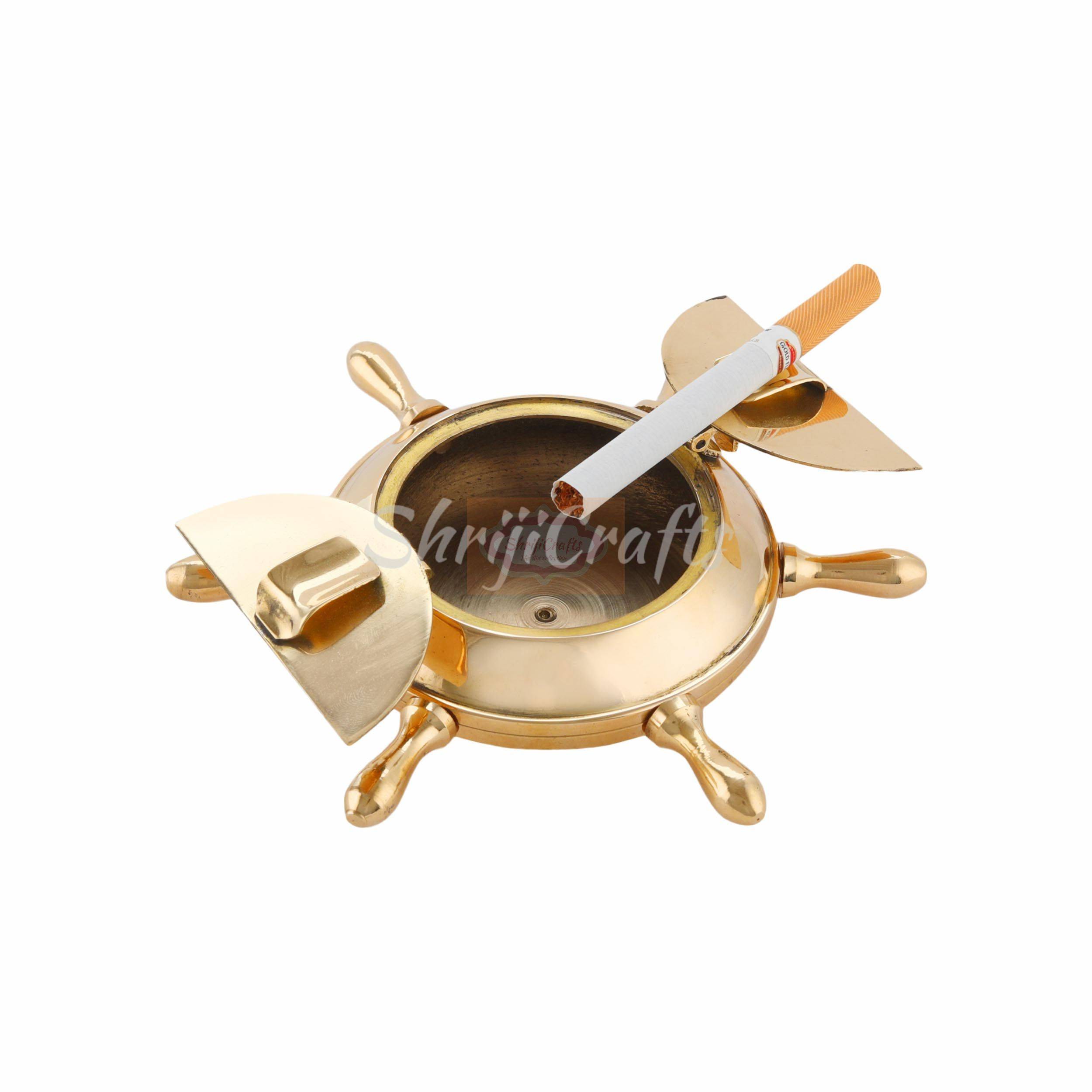Handcrafted brass ashtray featuring a classic nautical ship wheel design with a polished finish - View 2