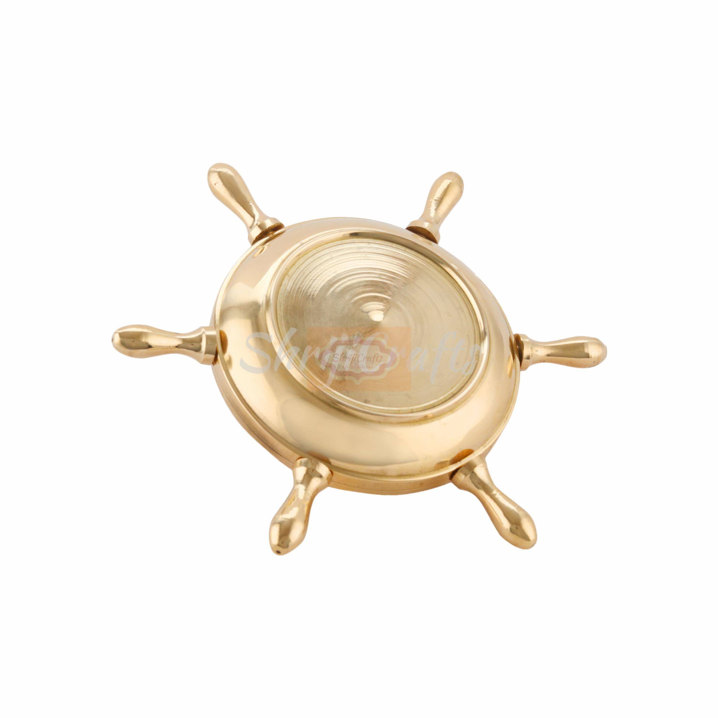 Handcrafted brass ashtray featuring a classic nautical ship wheel design with a polished finish - View 4